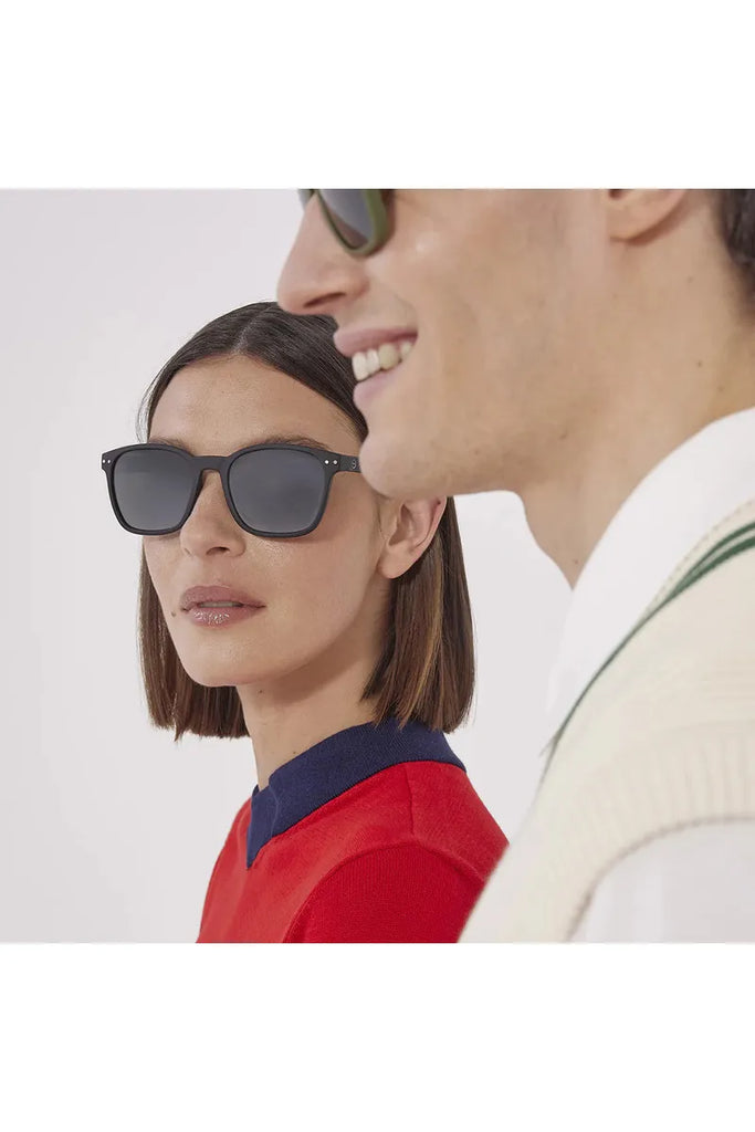 Two individuals wearing Izipizi polarised sunglasses against a plain background.