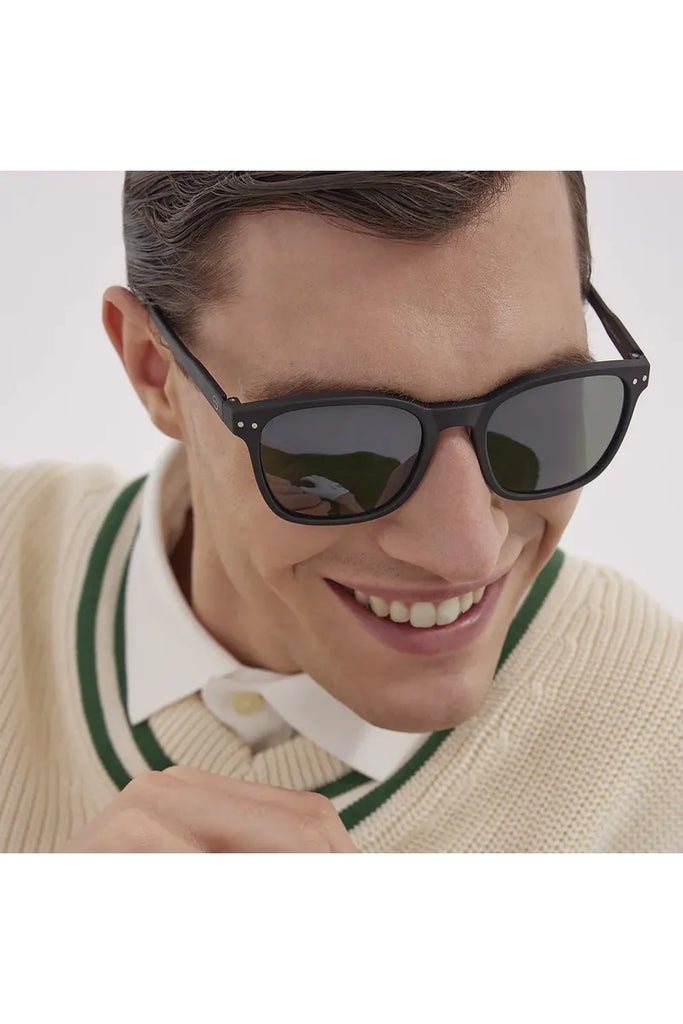 A man wearing black Izipizi polarised sunglasses with a neutral background