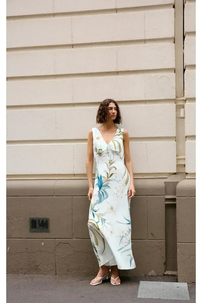 Woman wearing a floral sleeveless dress. Kinney Alice dress in Portofino print.