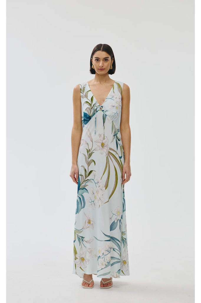 Woman wearing a floral sleeveless dress on a white background. Kinney Alice dress in Portofino print.