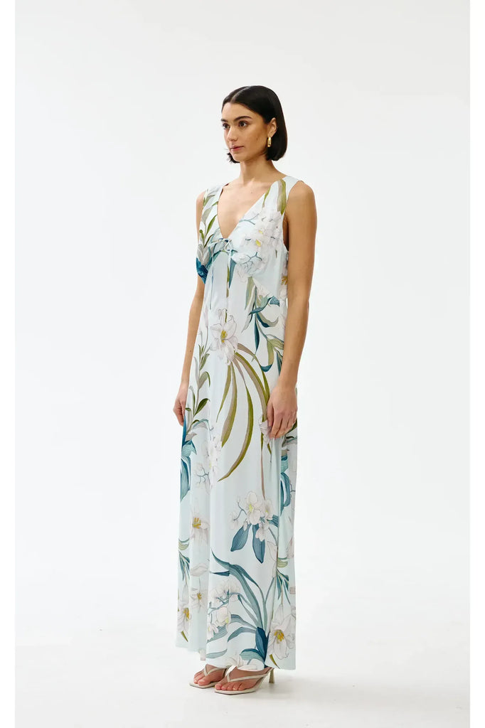 Woman wearing a floral sleeveless dress on a white background. Kinney Alice dress in Portofino print.