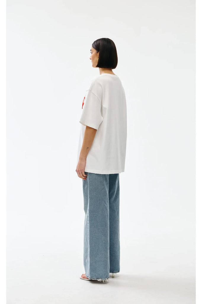 Person wearing a white t-shirt and blue jeans on a white background