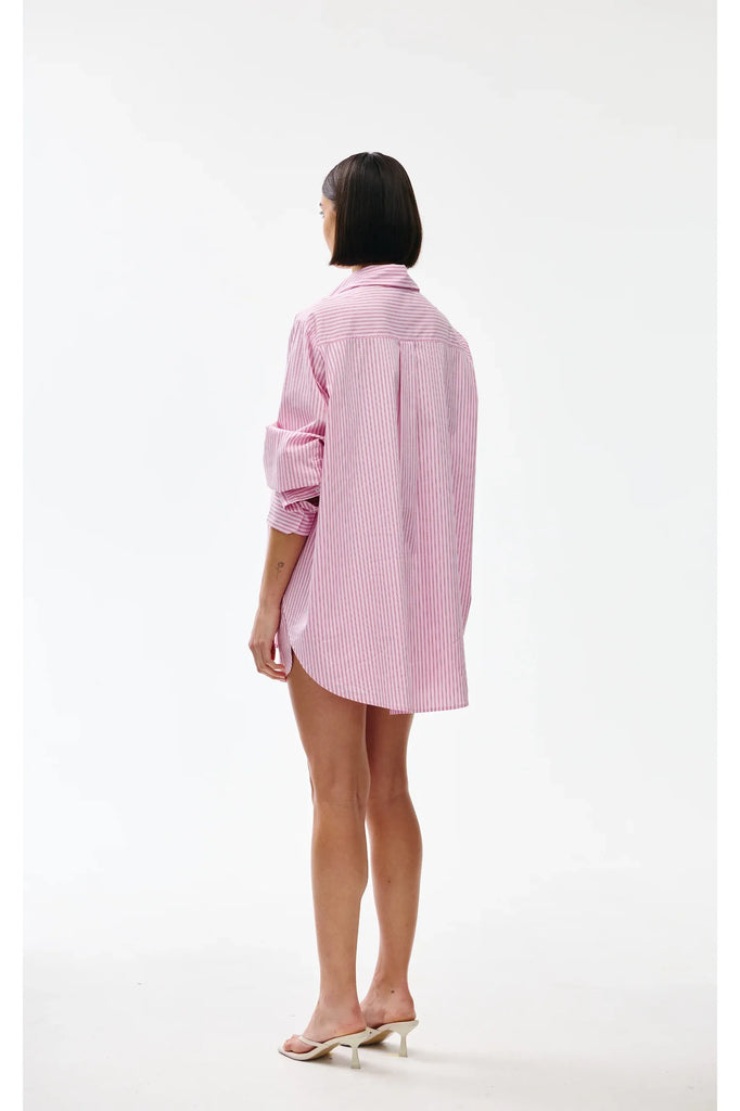 Person wearing a pink striped shirt on a white background