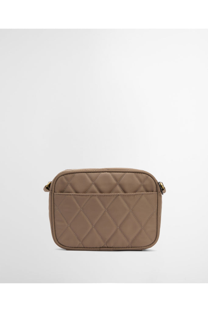 Quilted beige handbag on a light gray background. Barbour Quilted crossbody bag in sand.