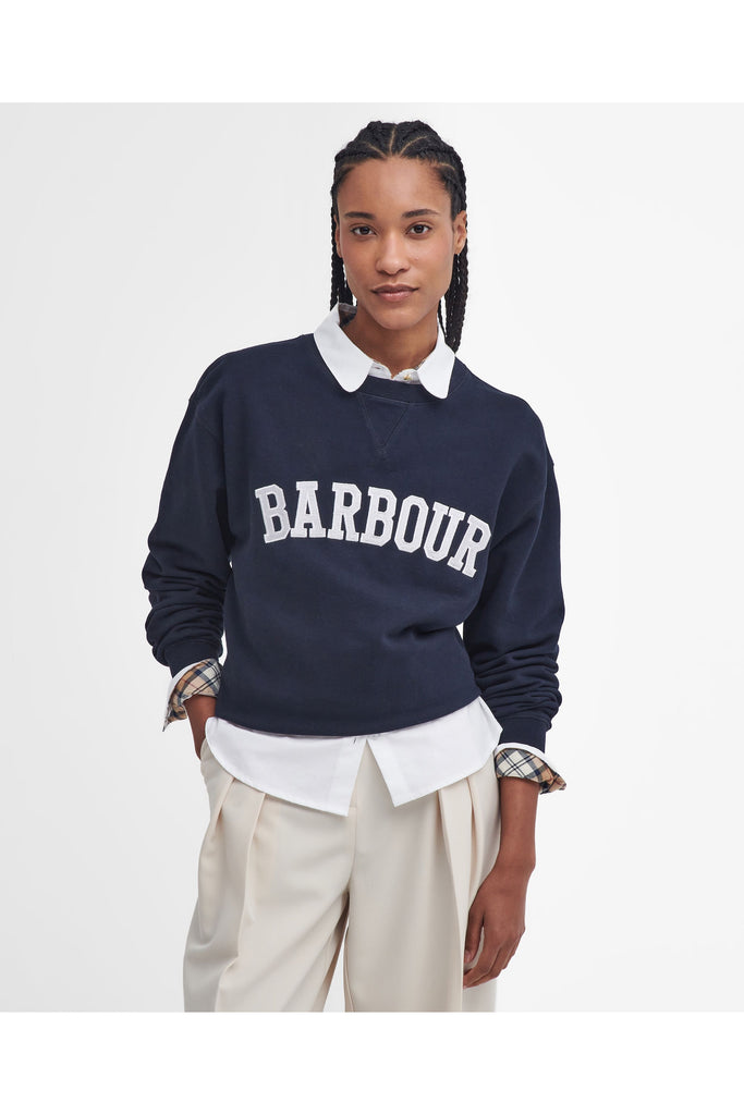 Person wearing a navy Barbour sweatshirt with a white collar on a light gray background. Northumberland Sweatshirt in Navy and Cloud.