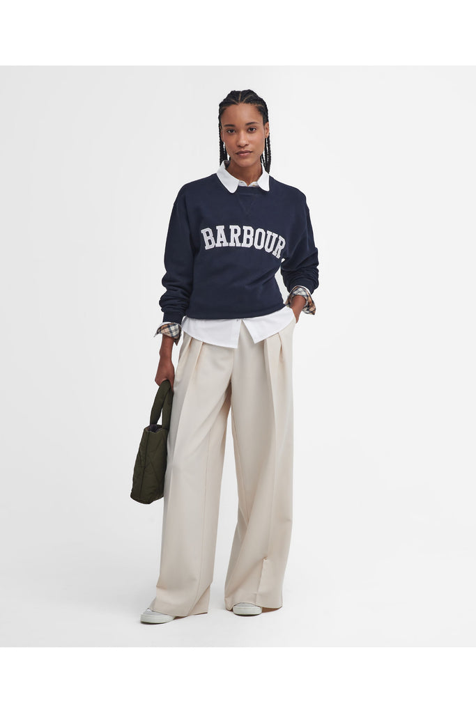 Person wearing a navy Barbour sweatshirt with a white collar on a light gray background. Northumberland Sweatshirt in Navy and Cloud.