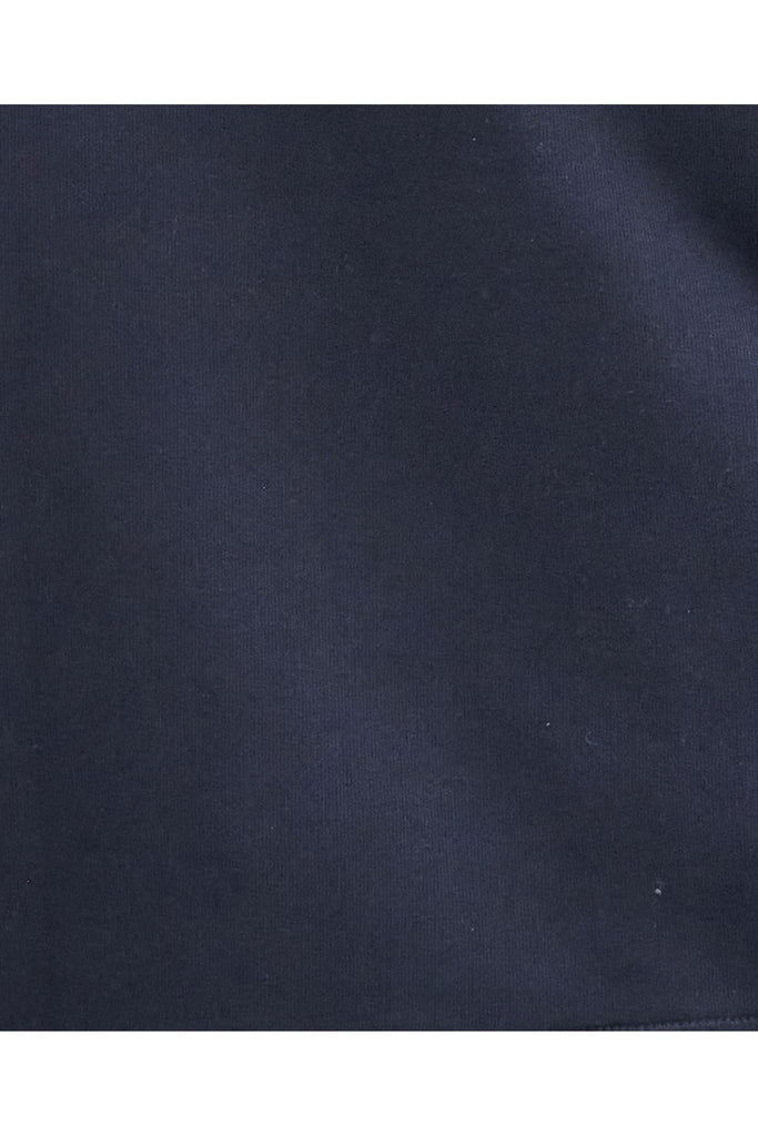 Person wearing a navy Barbour sweatshirt with a white collar on a light gray background. Northumberland Sweatshirt in Navy and Cloud.