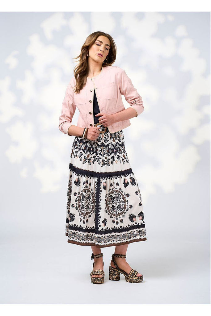 Woman wearing a navy tee and pink jacket with Loobies Story Zoe Skirt