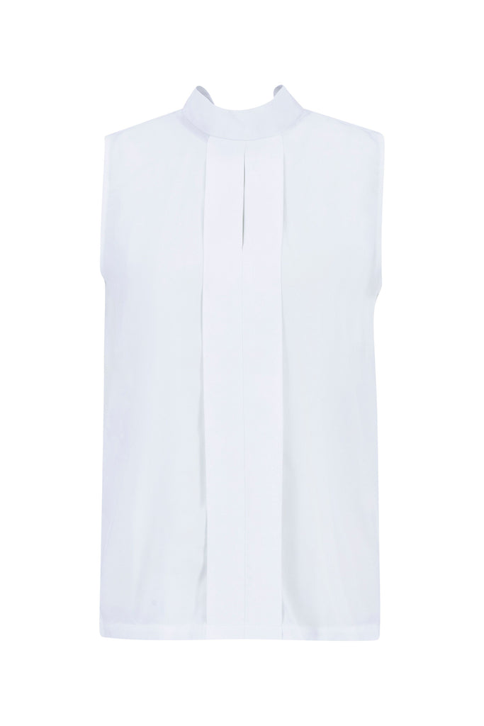 Woman wearing a white sleeveless top and black pants on a plain background. Barbour Sophia Top in White.