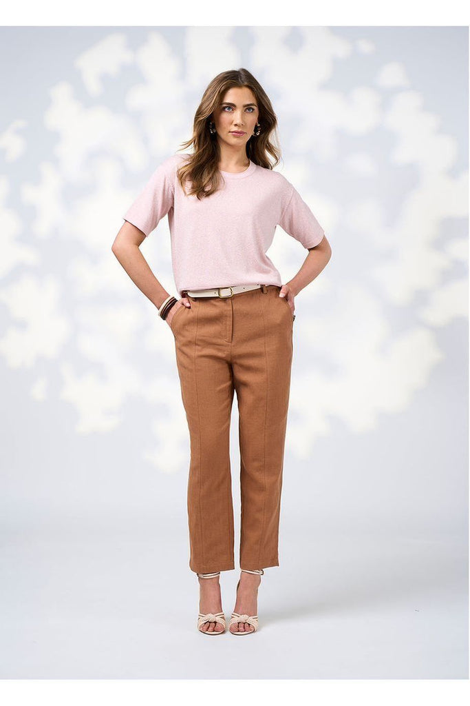 Woman wearing the Quinn Pant in Toffee from Loobie's Story with a pink top and sandals.