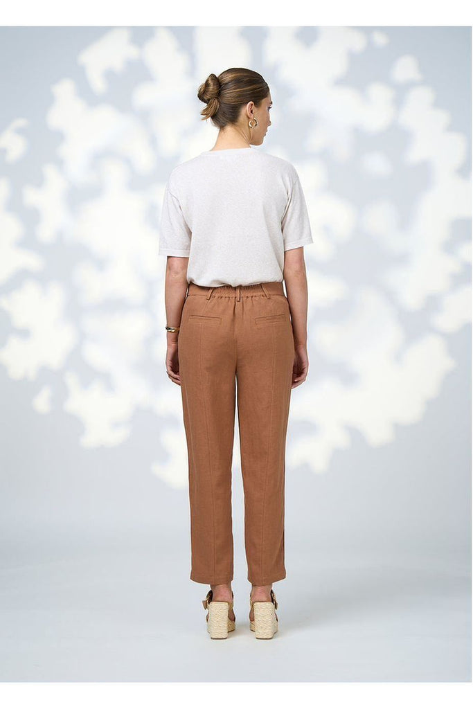 Woman wearing the Quinn Pant in Toffee from Loobie's Story with a white top and sandals.