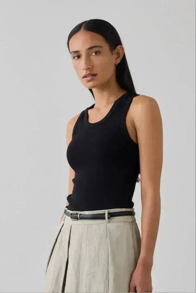 Woman wearing a black tank top. Laing Cotton Tank in black.