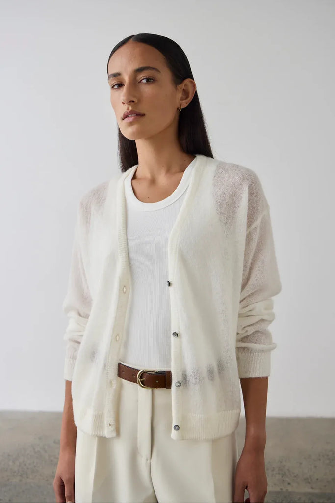 Woman wearing a white sleeveless top. Laing Cotton Tank in Ecru.