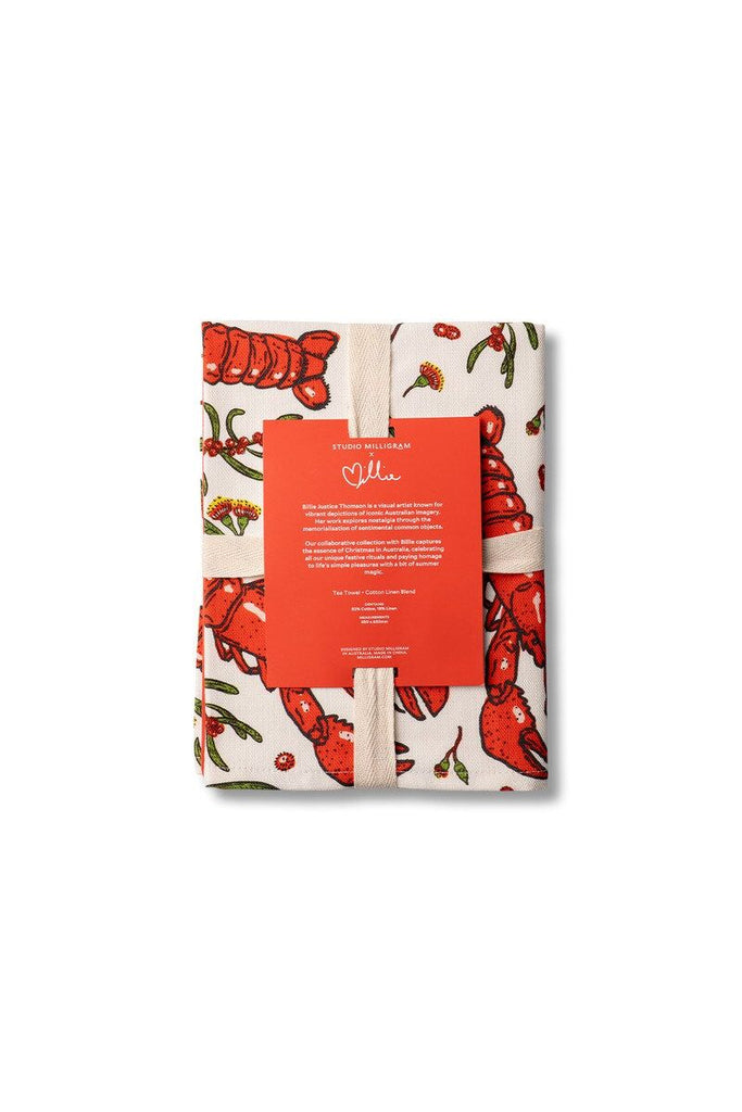 Studio Milligram packaged lobster tea towel design and a visible brand label on a white background.