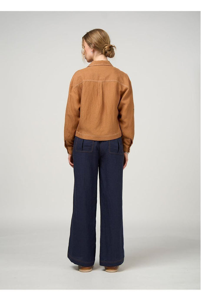 Person wearing a Madly Sweetly Aspect Jacket in Cinnamon with navy pants