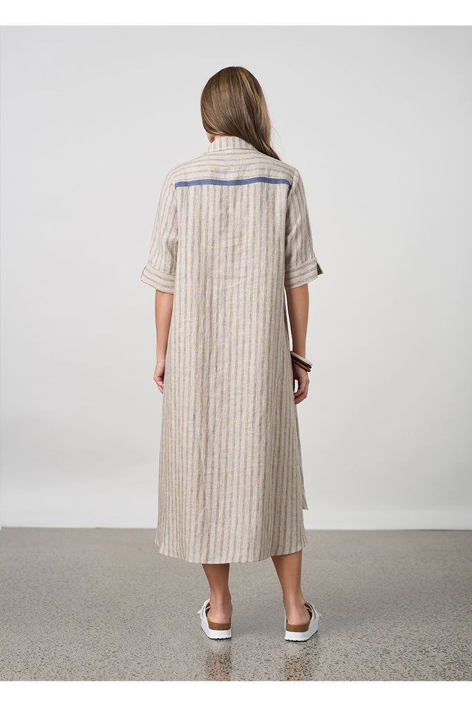 Woman wearing a long striped beige shirt dress on a plain background. Madly Sweetly Interval Shirt dress in pumice.