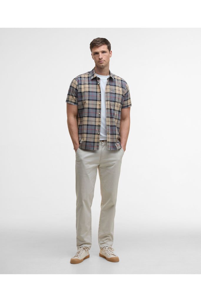 Man wearing a plaid short-sleeve shirt on a plain background. Barbour Gordon Summer Shirt in Dress Tartan.