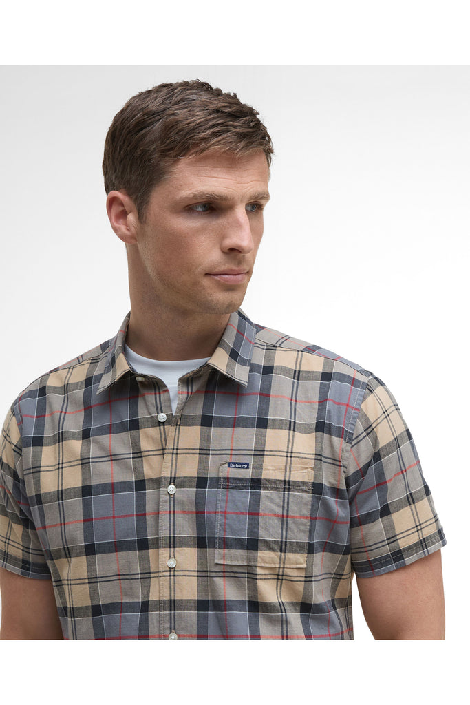 Man wearing a plaid short-sleeve shirt on a plain background. Barbour Gordon Summer Shirt in Dress Tartan.