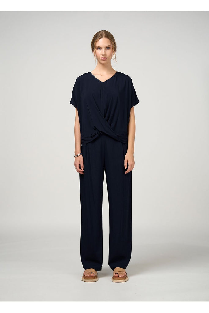 Woman wearing a black outfit on a white background. Madly Sweetly Occasion Top in Black.