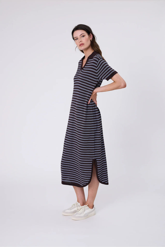 Woman wearing a chocolate brown and blue striped polo dress on a white background. Marlow Chime Knit Polo Dress in Carob Stripe.