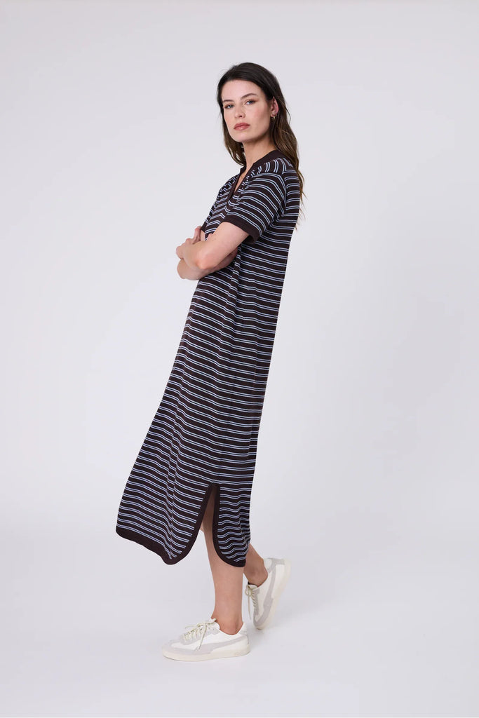 Woman wearing a chocolate brown and blue striped polo dress on a white background. Marlow Chime Knit Polo Dress in Carob Stripe.