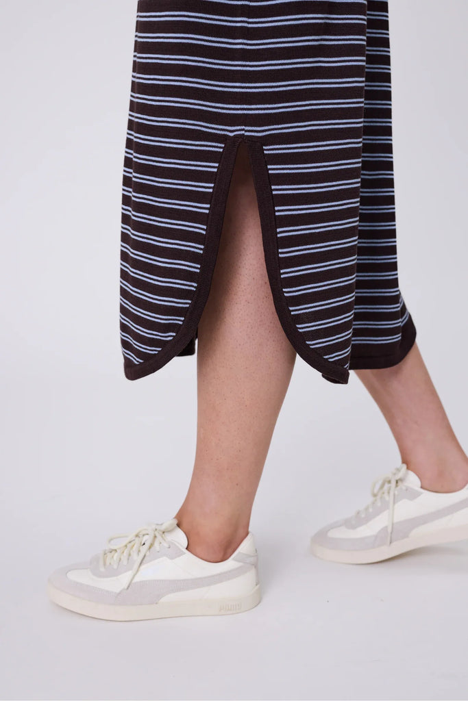 Woman wearing a chocolate brown and blue striped polo dress on a white background. Marlow Chime Knit Polo Dress in Carob Stripe.
