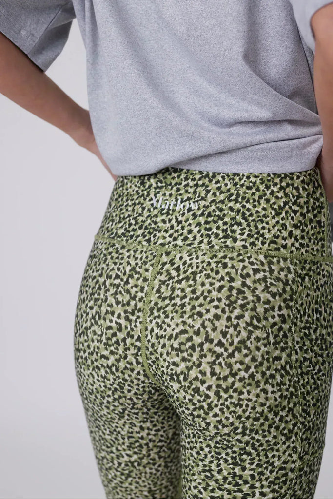 Person wearing green patterned shorts on a plain background. Marlow Circuit Bike Short in a green Willow Print.