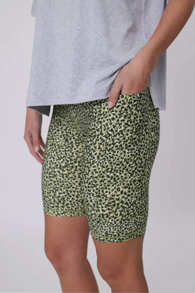 Person wearing green patterned shorts on a plain background. Marlow Circuit Bike Short in a green Willow Print.