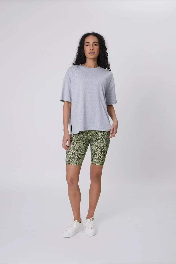 Person wearing green patterned shorts on a plain background. Marlow Circuit Bike Short in a green Willow Print.