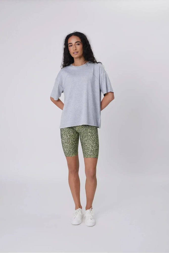 Person wearing green patterned shorts on a plain background. Marlow Circuit Bike Short in a green Willow Print.