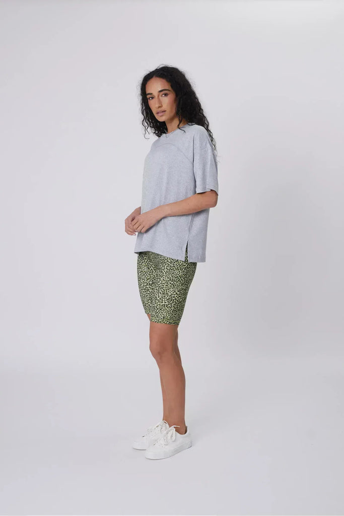 Person wearing green patterned shorts on a plain background. Marlow Circuit Bike Short in a green Willow Print.