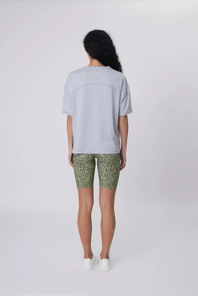 Person wearing green patterned shorts on a plain background. Marlow Circuit Bike Short in a green Willow Print.