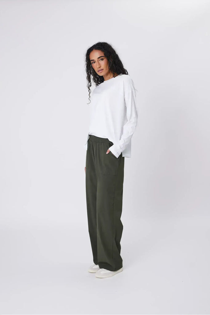 Person wearing green pants on a white background. Marlow Intrepid Pant 2.0 Olive.