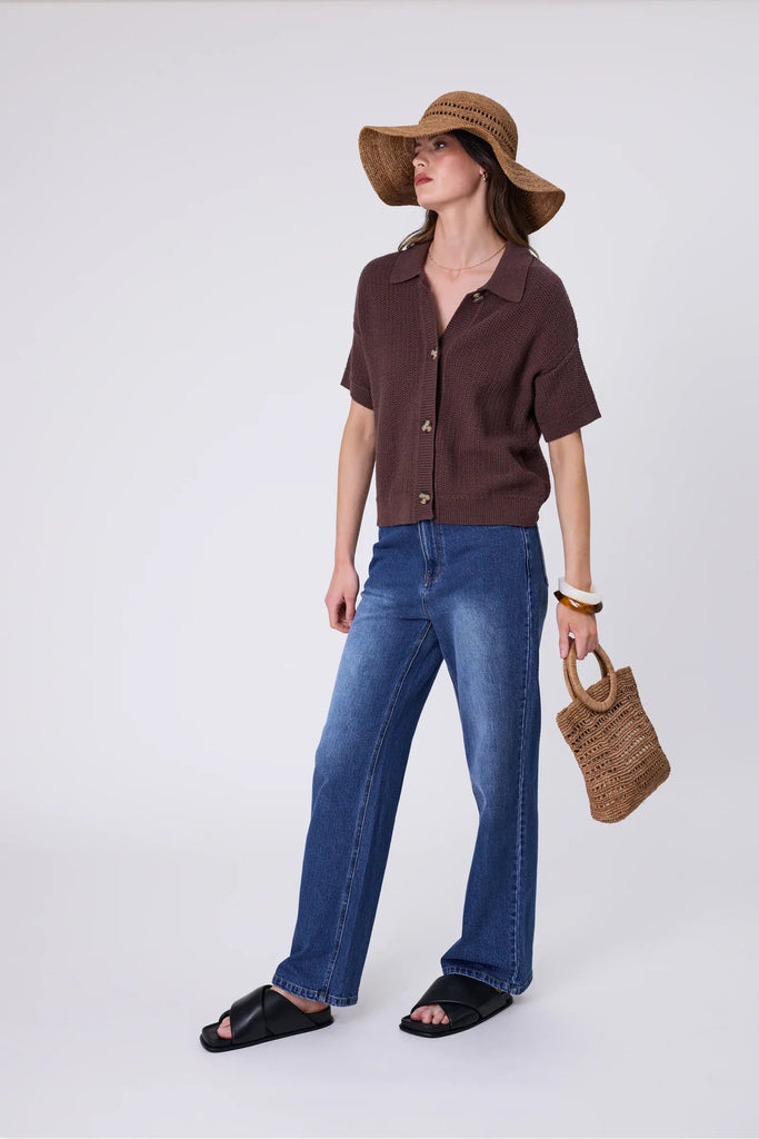 Woman wearing a wide brim sun hat and brown top against a grey background. Marlow Mykonos Wide Brim Hat in Tea.