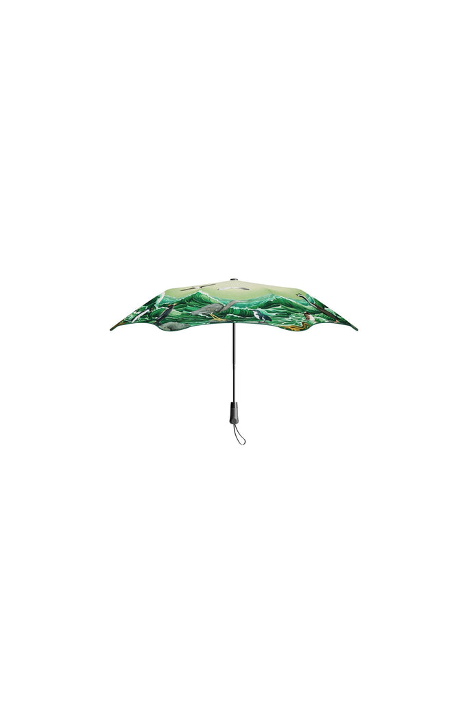 Blunt x Forest & Bird 2025 Limited Edition Metro Umbrella. Featuring artwork by Kiwi artist Tanya Wolfkamp. Showcasing Aotearoa's native sea and shore birds.  Green in colour, the bird-themed umbrella sits vertically against a white background.
