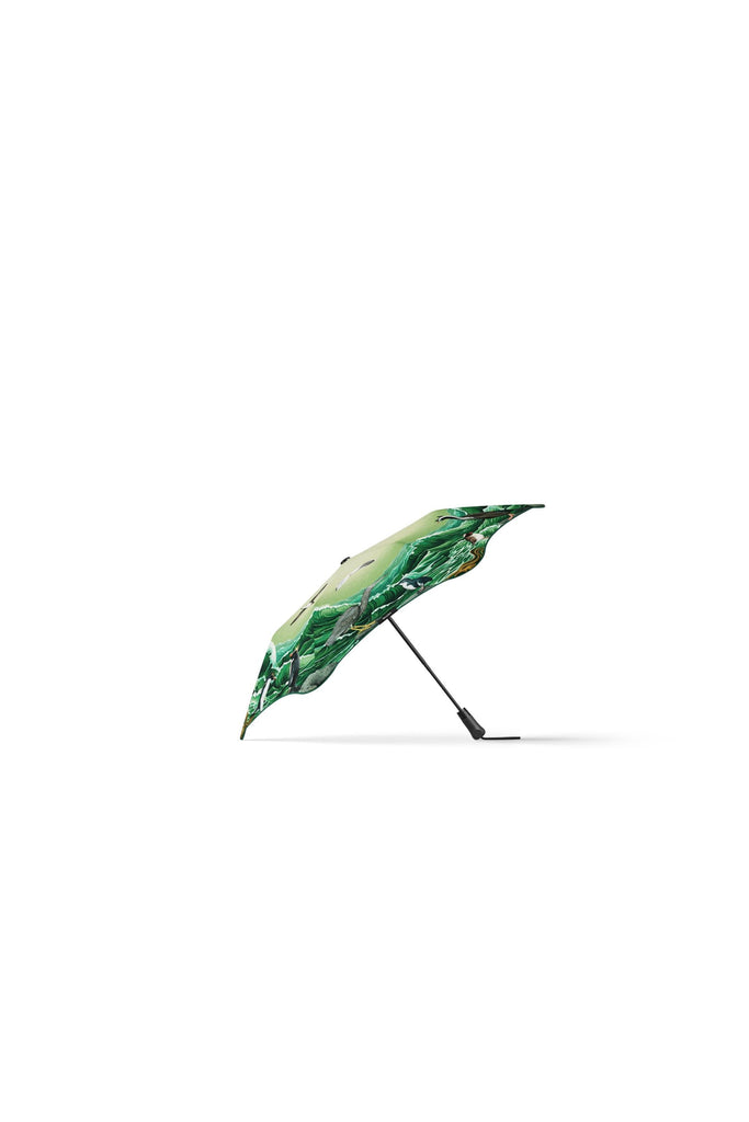 Blunt x Forest & Bird 2025 Limited Edition Metro Umbrella. Featuring artwork by Kiwi artist Tanya Wolfkamp. Showcasing Aotearoa's native sea and shore birds.  The image shows the umbrella on its side so as to catch a glimpse of the canopy  image featuring 16 native NZ sea and shore birds, and Aotearoa New Zealand’s coastal wildlife in a swirling, ocean-inspired design.