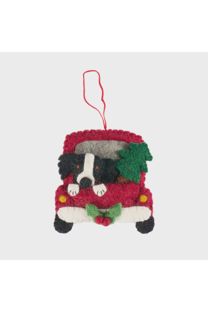 Handcrafted felt Christmas ornament featuring a Border Collie in a red vintage truck with festive greenery on a white background.