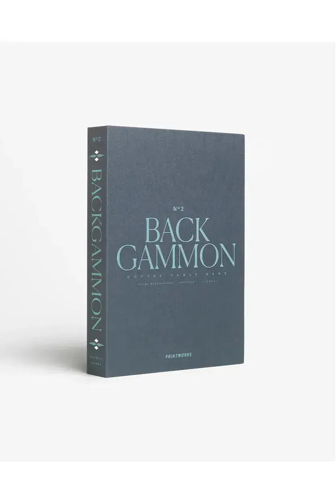 Printworks Backgammon Classic. The game comes in a grey box designed like a book, featuring turquoise writing that states the name of the game and the Printworks branding. The box is positioned against a white background.