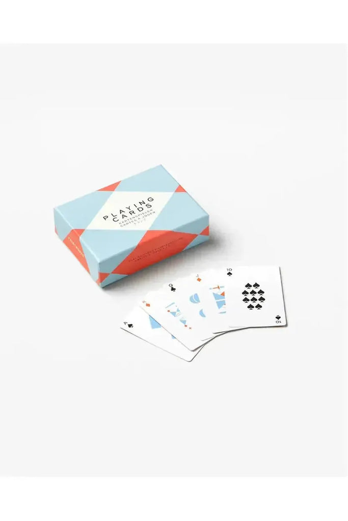 A delightful set of geometric playing cards rests on a bright white surface, accompanied by a charming pale blue, red, and white box that beautifully showcases the cards.