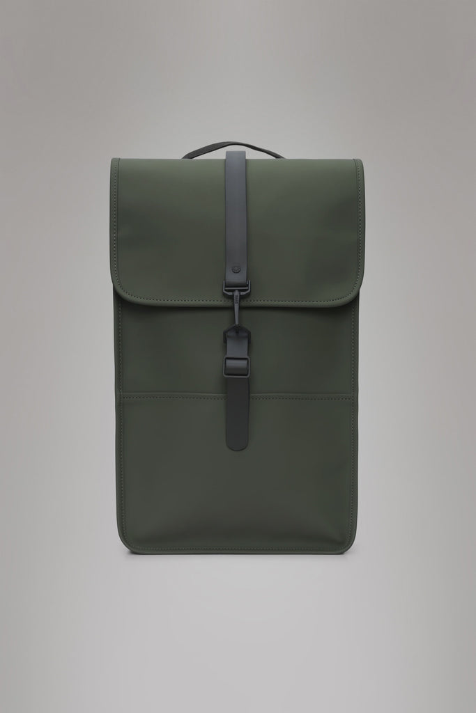 Green backpack with a black strap on a light gray background. Rains Green backpack.