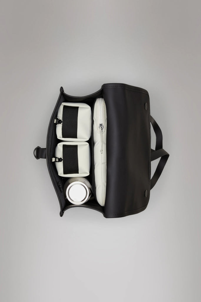 khaki green backpack against a plain background. Rains Green backpack.