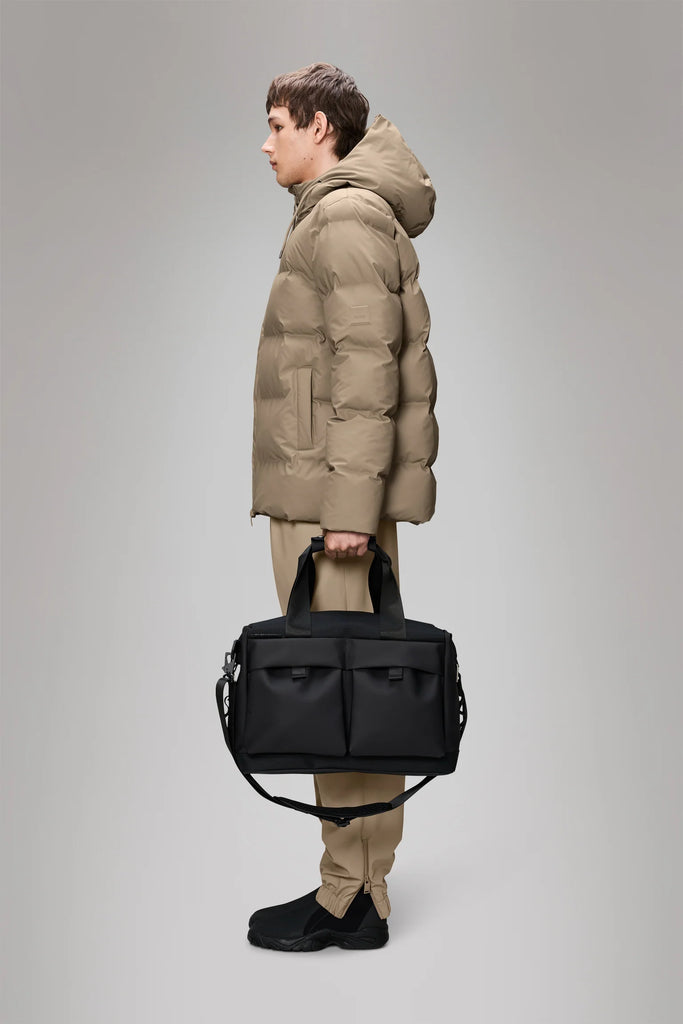 Rains Otaru Weekend Bag W3, Small, Black Travel + Weekender Bags person holding it.