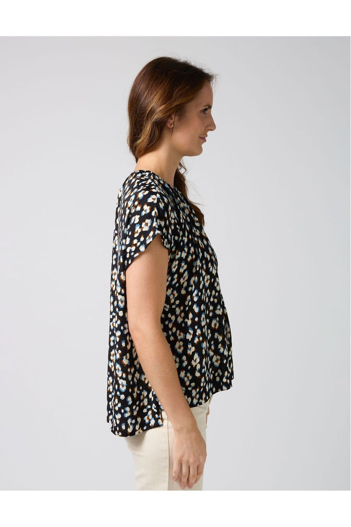 Woman wearing a Stella and Gemma Clio Top in Navy Leopard print against a white background side view