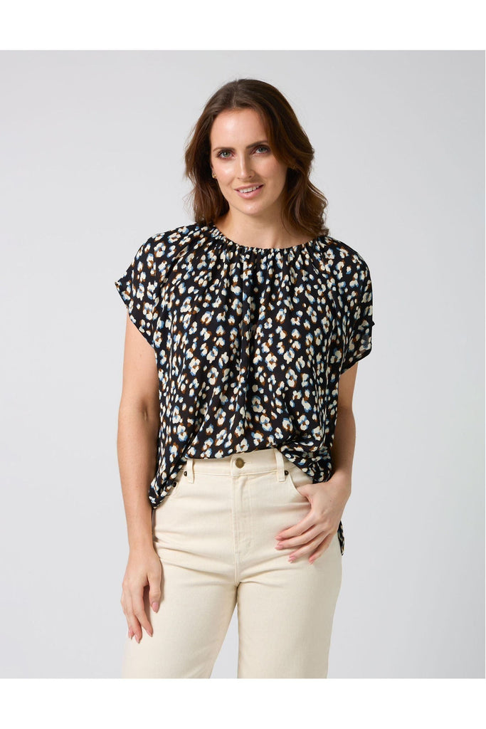Woman wearing a Stella and Gemma Clio Top in Navy Leopard print against a white background