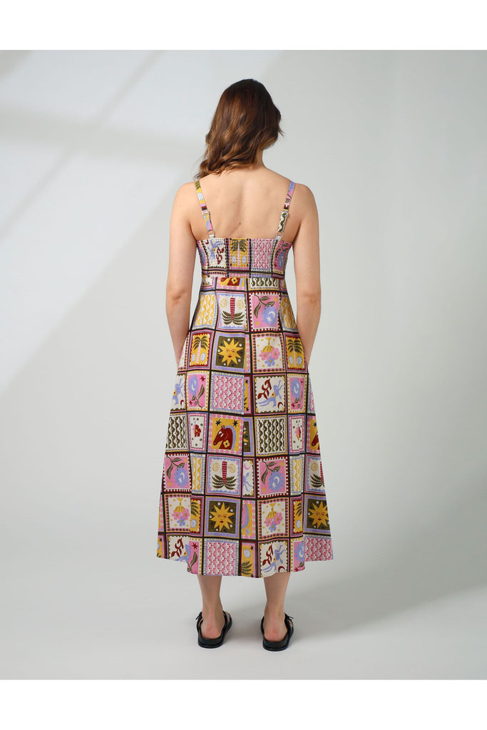 Woman wearing a colorful patchwork dress on a white background. Stella and Gemma Jude Dress in the Memories Of Morocco print