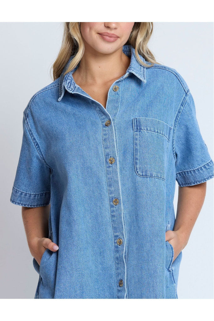 Woman wearing a Stella and Gemma Vinnie Dress in blue denim against a white background