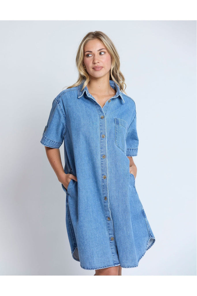 Woman wearing a Stella and Gemma Vinnie Dress in blue denim against a white background