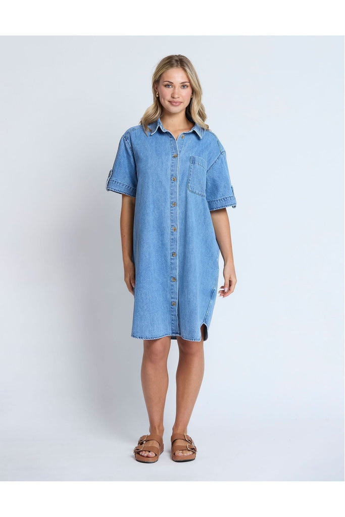 Woman wearing a Stella and Gemma Vinnie Dress in blue denim against a white background