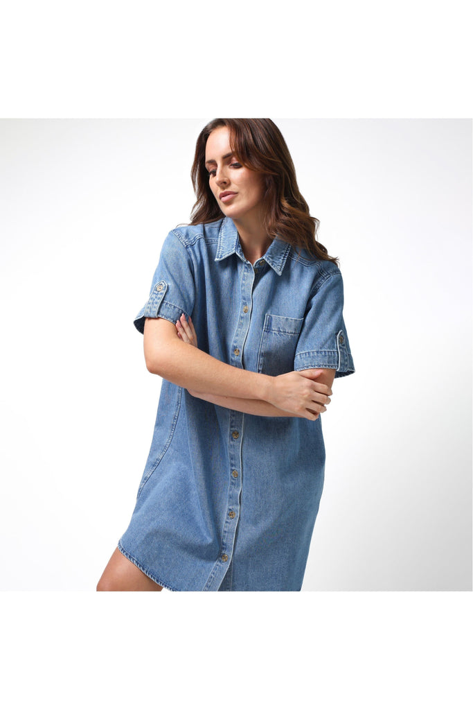 Woman wearing a Stella and Gemma Vinnie Dress in blue denim against a white background