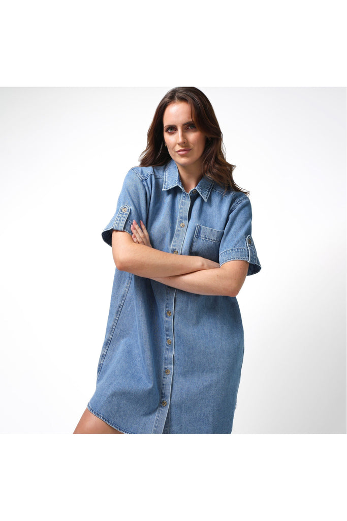 Woman wearing a Stella and Gemma Vinnie Dress in blue denim against a white background